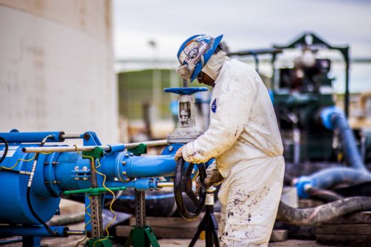 worker turning the valve